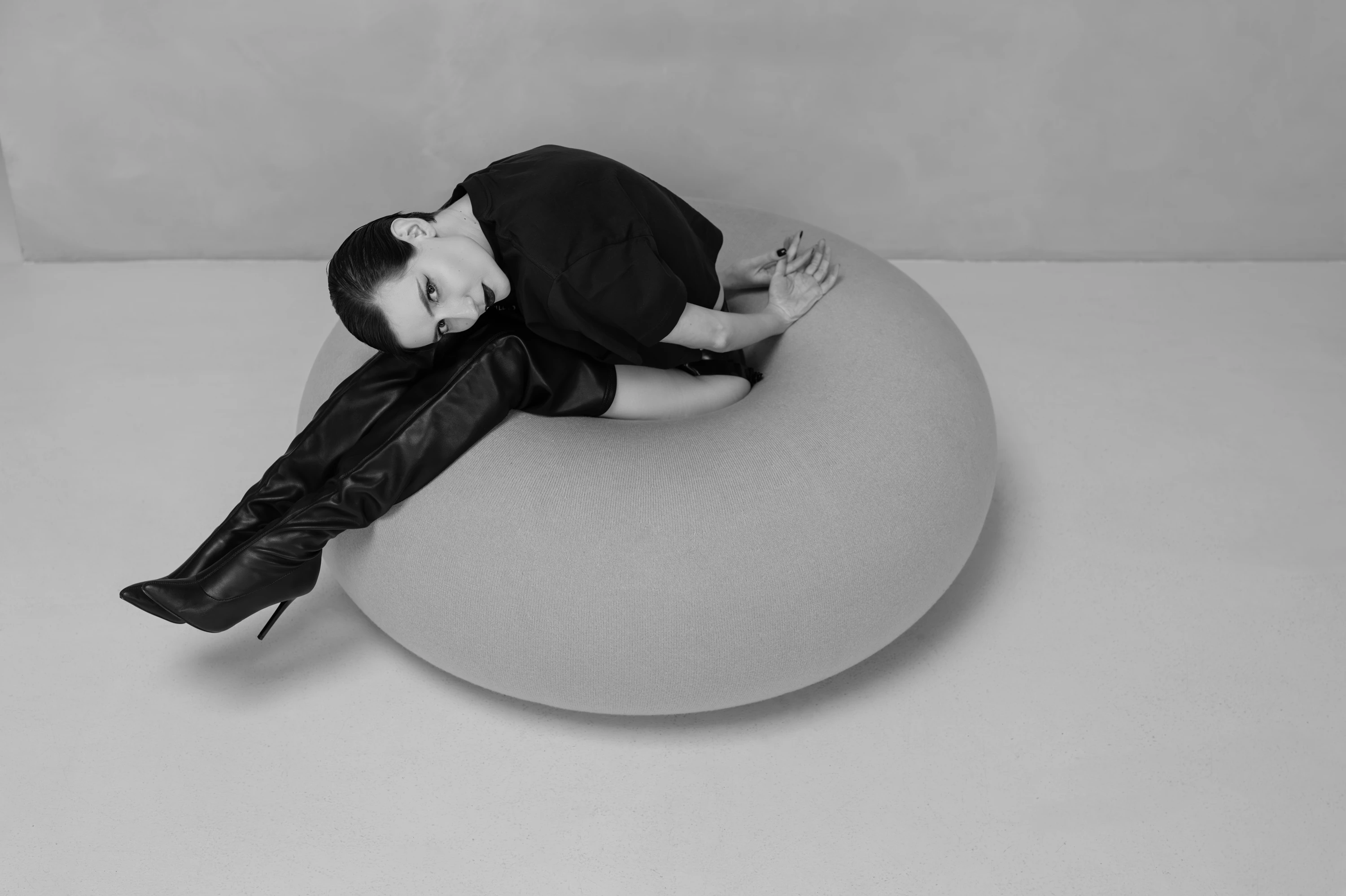 woman with boots bending forward on donut